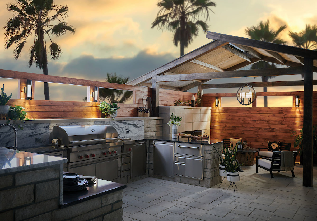 Hinkley Compass outdoor lighting with palm trees and sunset in the background.